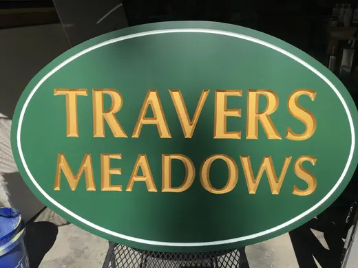 Travers Meadows oval community entrance sign